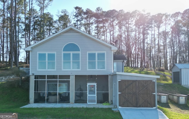 1550 Shady Oaks Ln, Greensboro, GA 30642 - back of house with a yard, driveway, a sunroom, and a garage