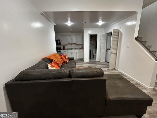 1550 Shady Oaks Ln, Greensboro, GA 30642 - living room with crown molding, baseboards, wood finished floors, and stairway