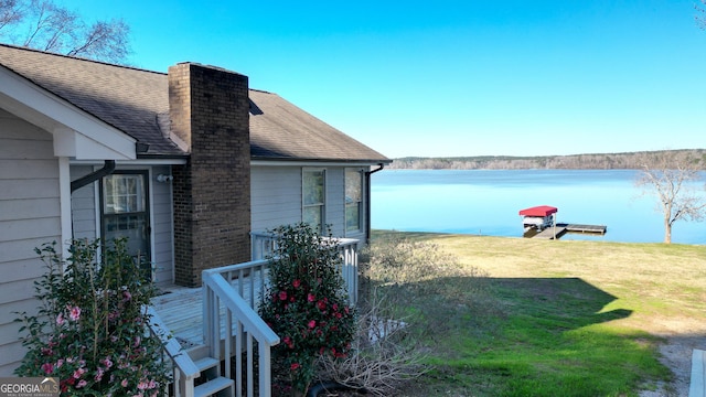 exterior space with a dock and a water view