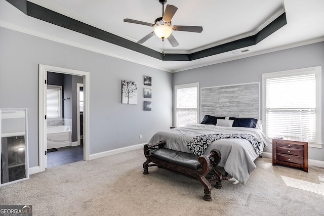 bedroom featuring a tray ceiling, carpet flooring, visible vents, and ornamental molding