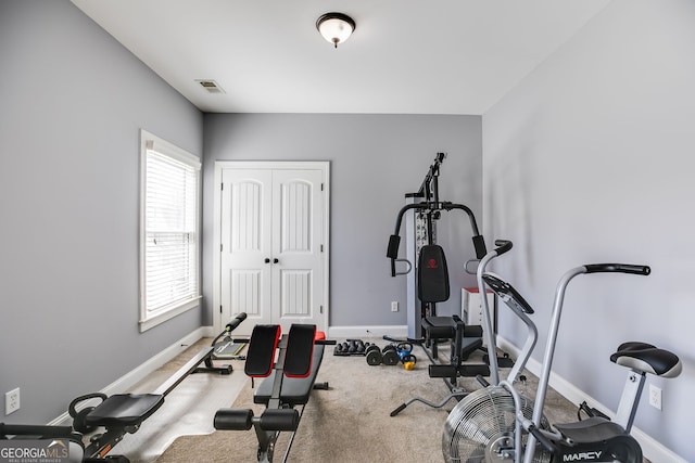 workout area featuring carpet, baseboards, and visible vents