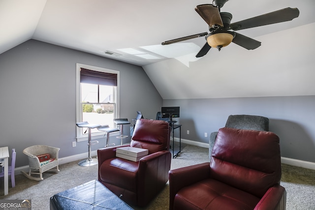 living area featuring visible vents, carpet floors, baseboards, ceiling fan, and vaulted ceiling