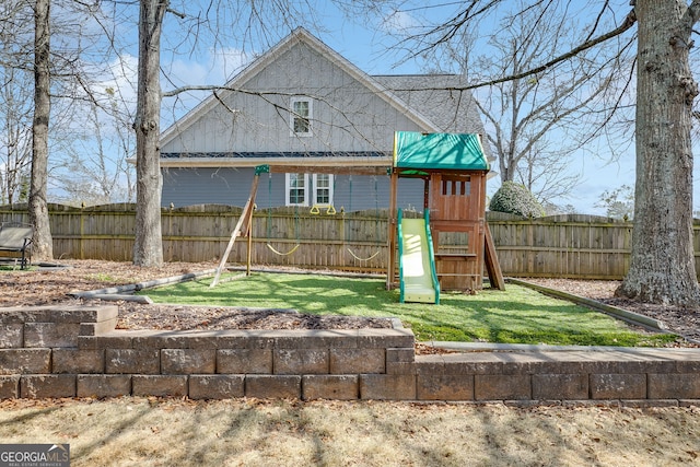 view of play area with a yard and a fenced backyard