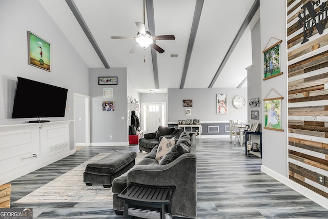 living area featuring visible vents, high vaulted ceiling, and wood finished floors