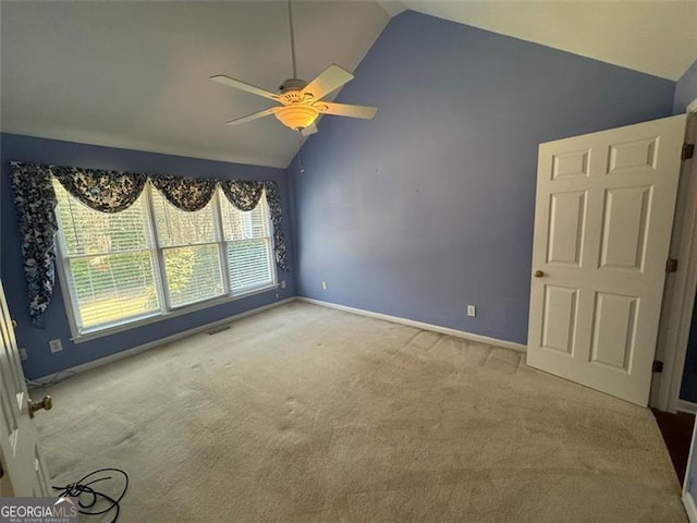 unfurnished room with a ceiling fan, visible vents, baseboards, high vaulted ceiling, and carpet flooring