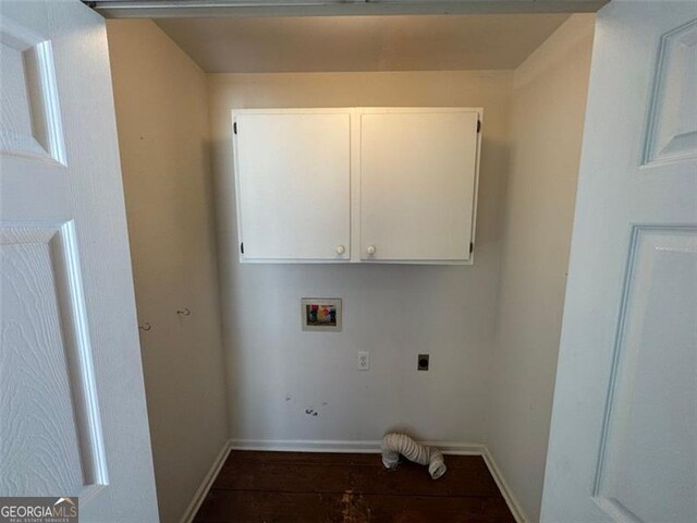 clothes washing area with baseboards, cabinet space, electric dryer hookup, washer hookup, and dark wood-type flooring