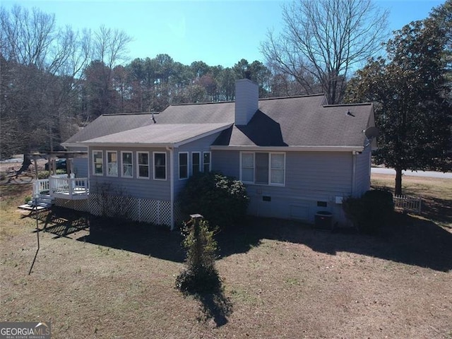 rear view of house featuring a lawn, cooling unit, a chimney, a deck, and crawl space