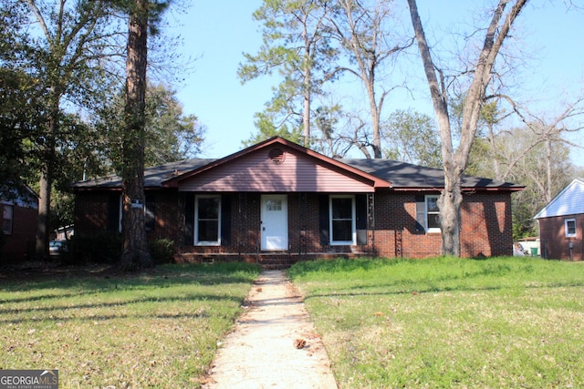 ranch-style house with a front lawn and brick siding