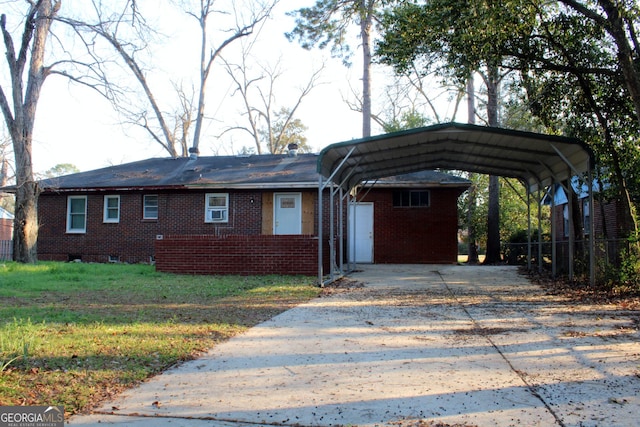 view of front facade with fence, driveway, a carport, a front lawn, and brick siding