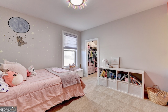 carpeted bedroom with a spacious closet and a closet