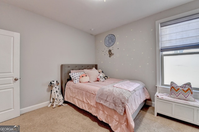 carpeted bedroom featuring baseboards
