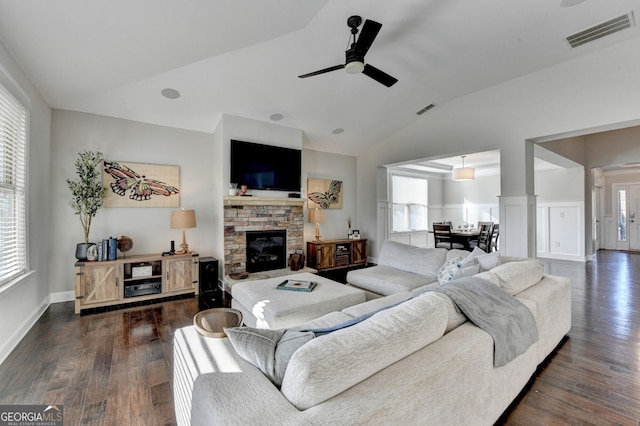living room with ceiling fan, visible vents, vaulted ceiling, and a wealth of natural light