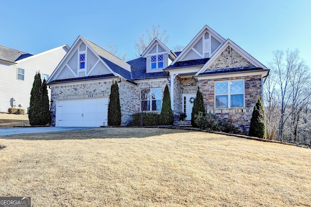 craftsman-style house featuring a garage, a front yard, and driveway