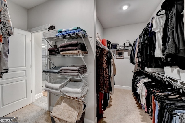 walk in closet with carpet floors
