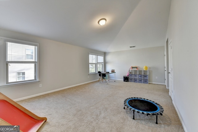 interior space featuring vaulted ceiling, baseboards, visible vents, and carpet floors