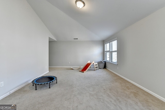 game room with baseboards, visible vents, carpet, and vaulted ceiling