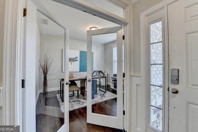 foyer featuring french doors, baseboards, visible vents, and dark wood-style floors