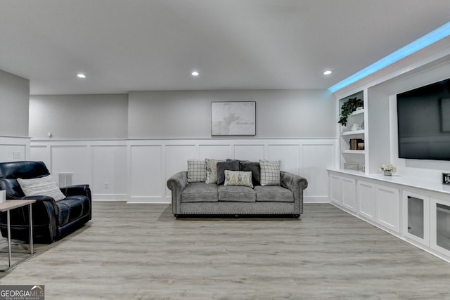 living room featuring visible vents, wood finished floors, built in features, and recessed lighting