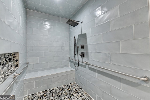 full bathroom featuring tiled shower