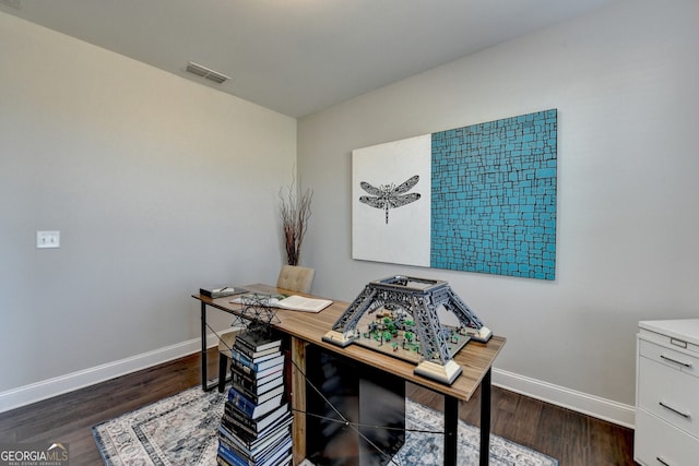 home office with baseboards, visible vents, and wood finished floors