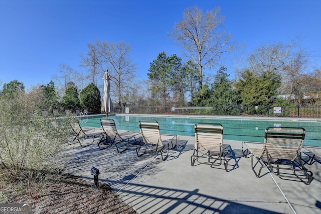 pool featuring a patio and fence