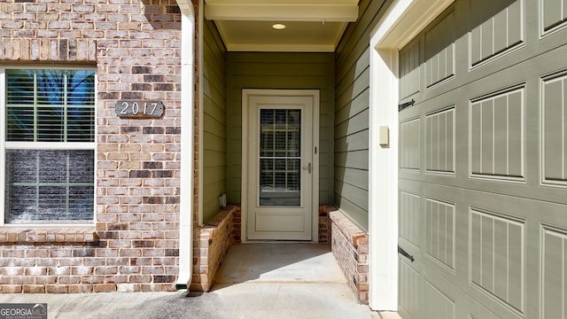 property entrance with brick siding