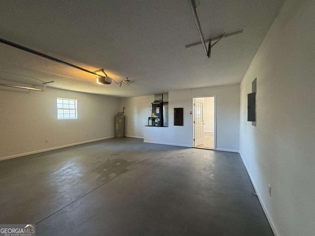 garage with water heater, baseboards, a garage door opener, and electric panel