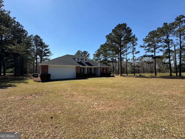 exterior space featuring a front lawn, brick siding, a garage, and driveway