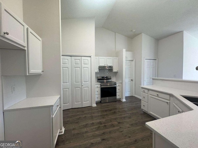 kitchen with electric range, under cabinet range hood, dark wood finished floors, white cabinets, and light countertops