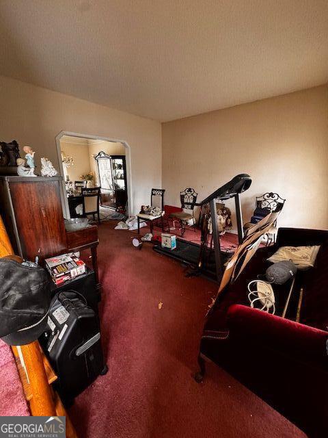 miscellaneous room featuring a textured ceiling and carpet floors