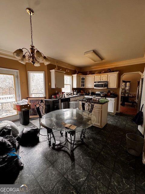 dining room with a notable chandelier and ornamental molding