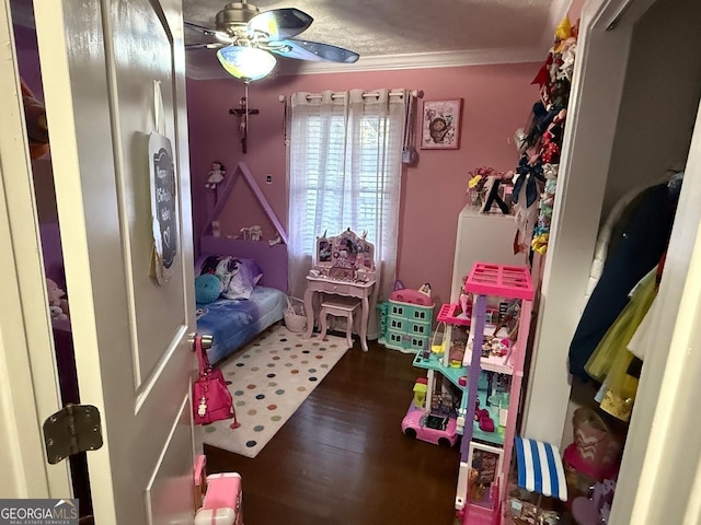 bedroom featuring a ceiling fan, wood finished floors, and ornamental molding