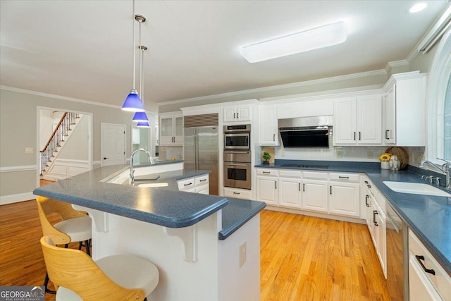 kitchen with dark countertops, a sink, and appliances with stainless steel finishes