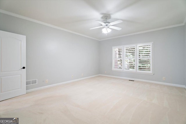 empty room with visible vents, a ceiling fan, light colored carpet, and ornamental molding