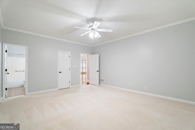 unfurnished bedroom featuring light carpet, baseboards, ornamental molding, and connected bathroom