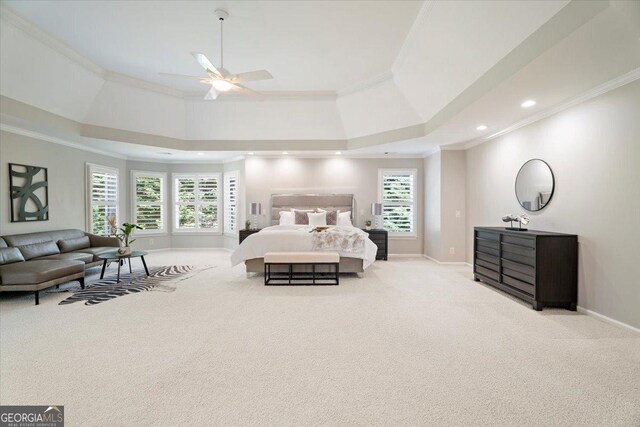 carpeted bedroom featuring crown molding, baseboards, and multiple windows