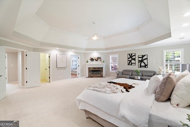 bedroom featuring a tray ceiling, carpet, and crown molding