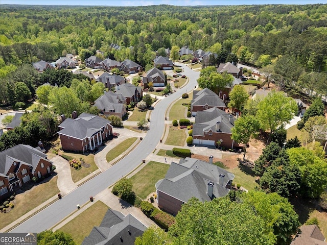 bird's eye view featuring a forest view and a residential view