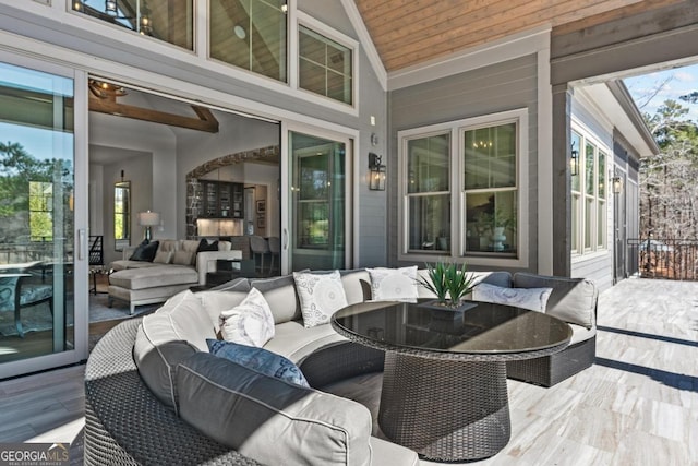 wooden terrace featuring outdoor lounge area and a patio area