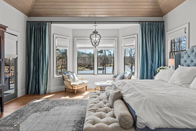 bedroom with a chandelier, wood ceiling, lofted ceiling, and wood finished floors