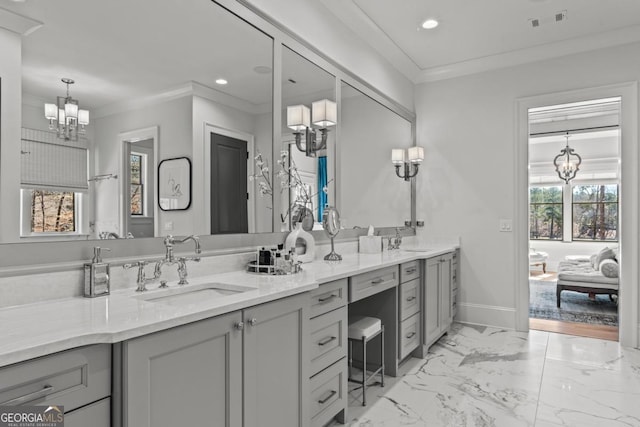 full bathroom featuring an inviting chandelier, crown molding, marble finish floor, and a sink