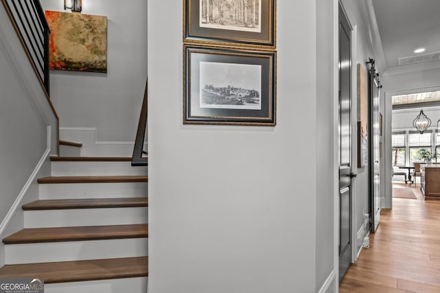 stairway featuring visible vents, recessed lighting, baseboards, and wood finished floors