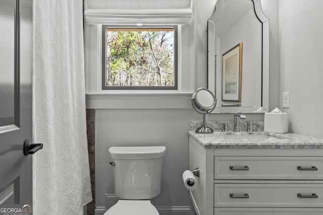 bathroom with toilet and vanity