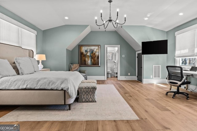 bedroom featuring visible vents, a chandelier, wood finished floors, and vaulted ceiling