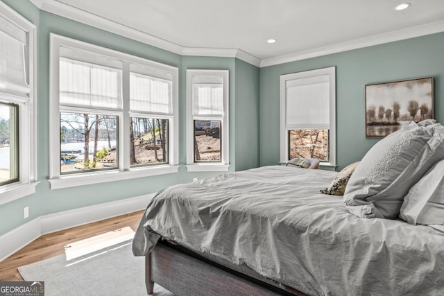 bedroom featuring recessed lighting, ornamental molding, baseboards, and wood finished floors
