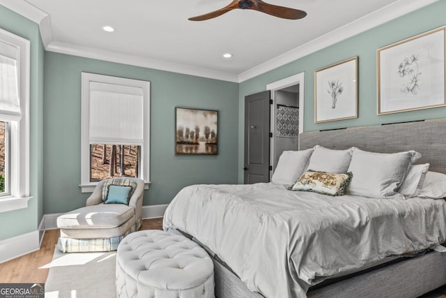 bedroom with recessed lighting, crown molding, baseboards, and wood finished floors