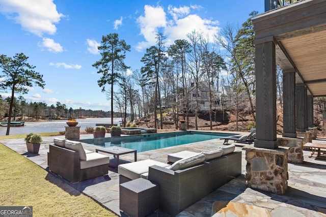 outdoor pool with a patio area and an in ground hot tub