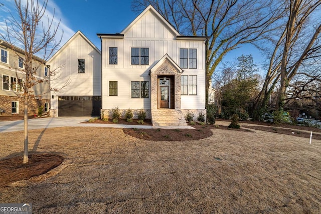 modern farmhouse style home featuring an attached garage, board and batten siding, and driveway