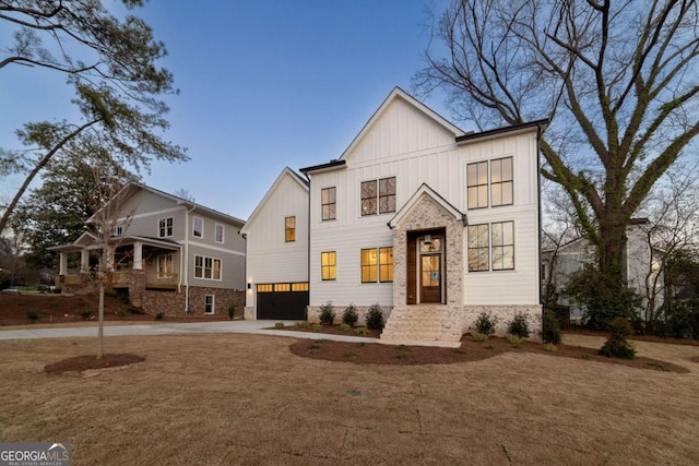 modern farmhouse style home with concrete driveway, a garage, and board and batten siding