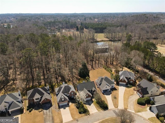 bird's eye view featuring a forest view, a residential view, and a water view